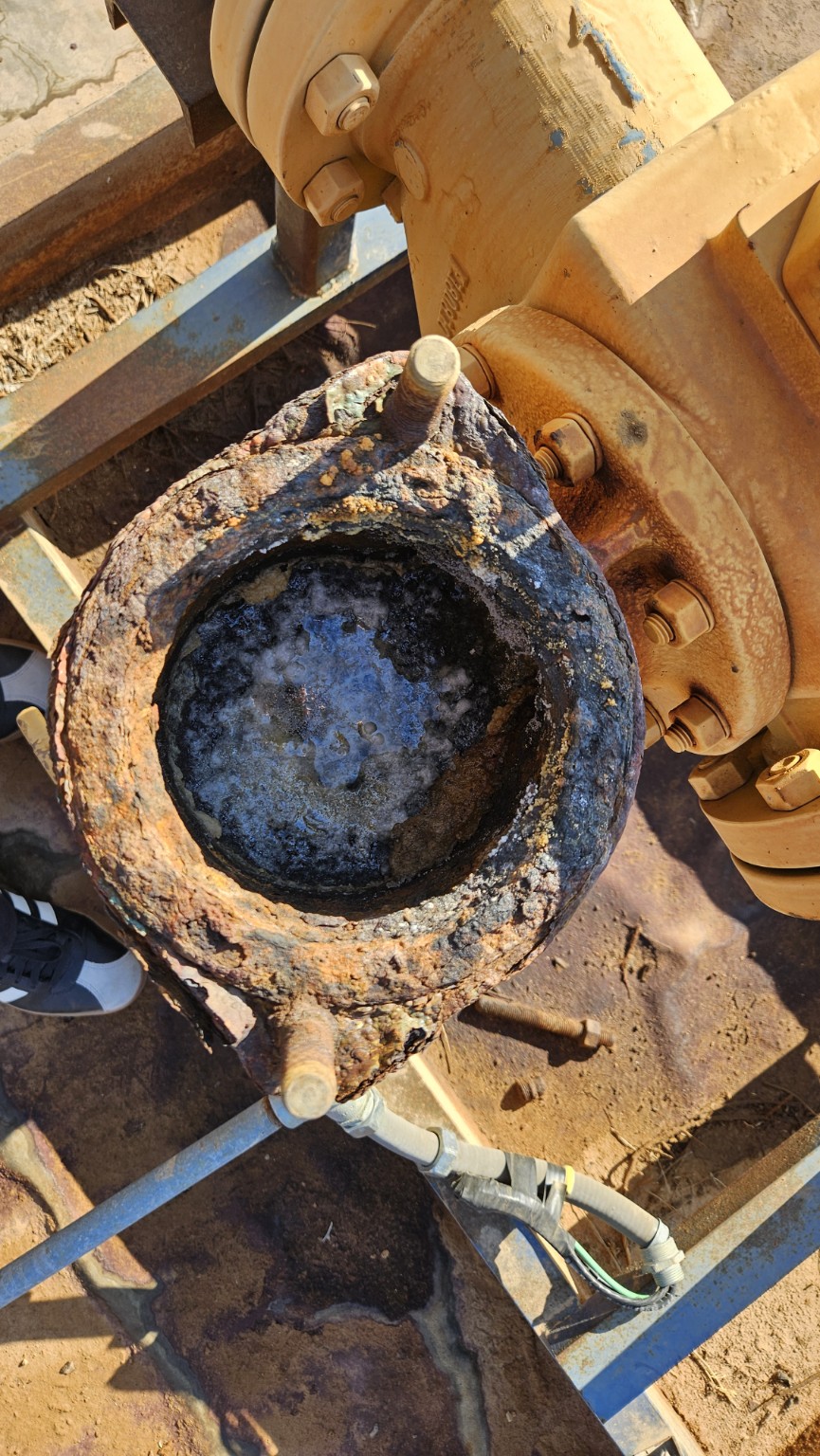 Severe corrosion and deposits inside an opened pipe flange